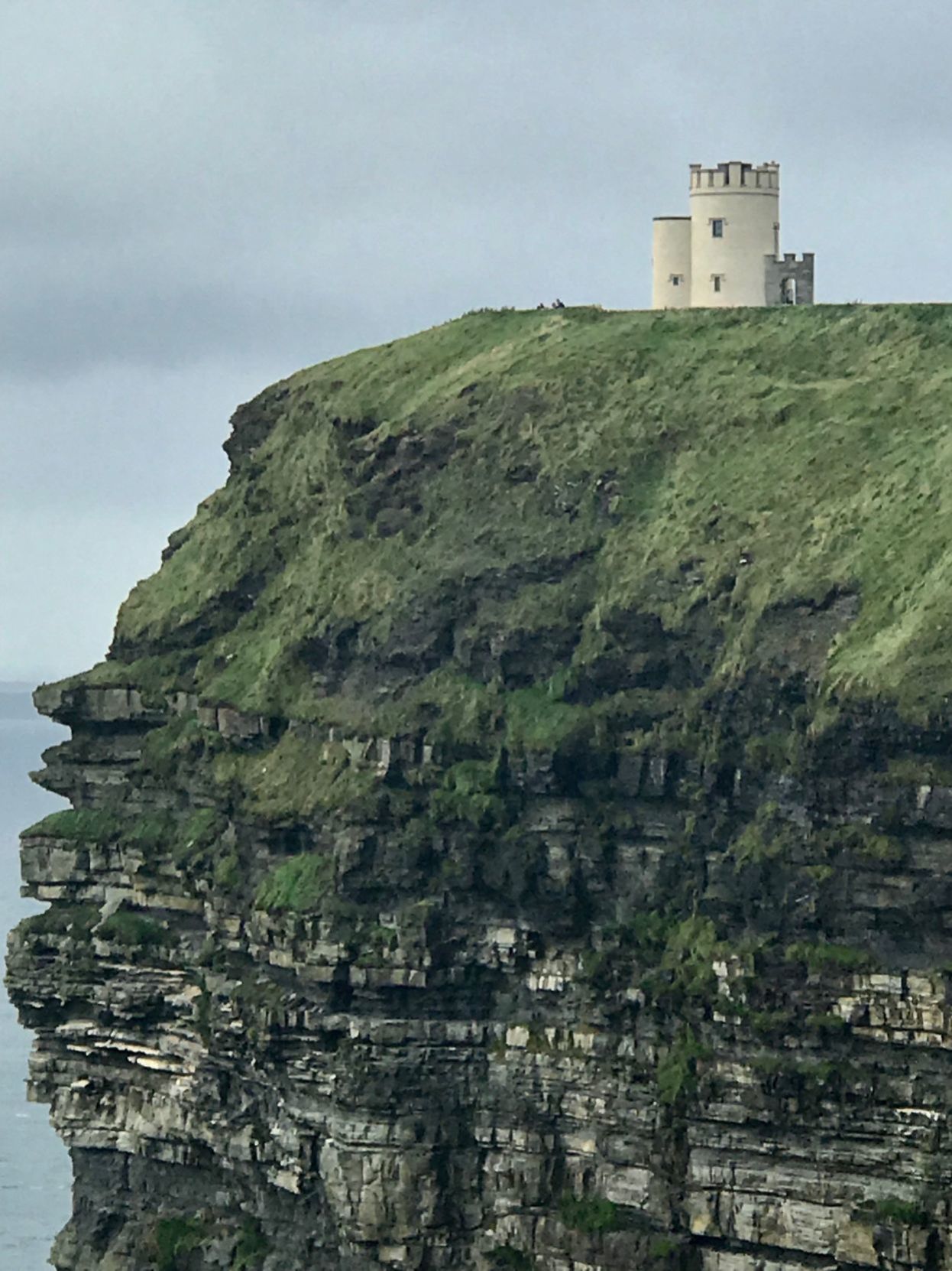 A tower sits at the highest point of the Cliffs of Moher